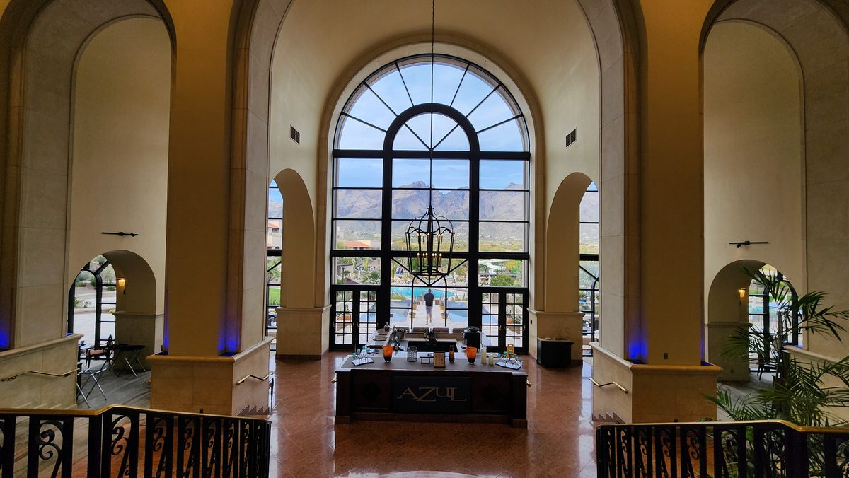 A tall arched window in an elegant resort lobby