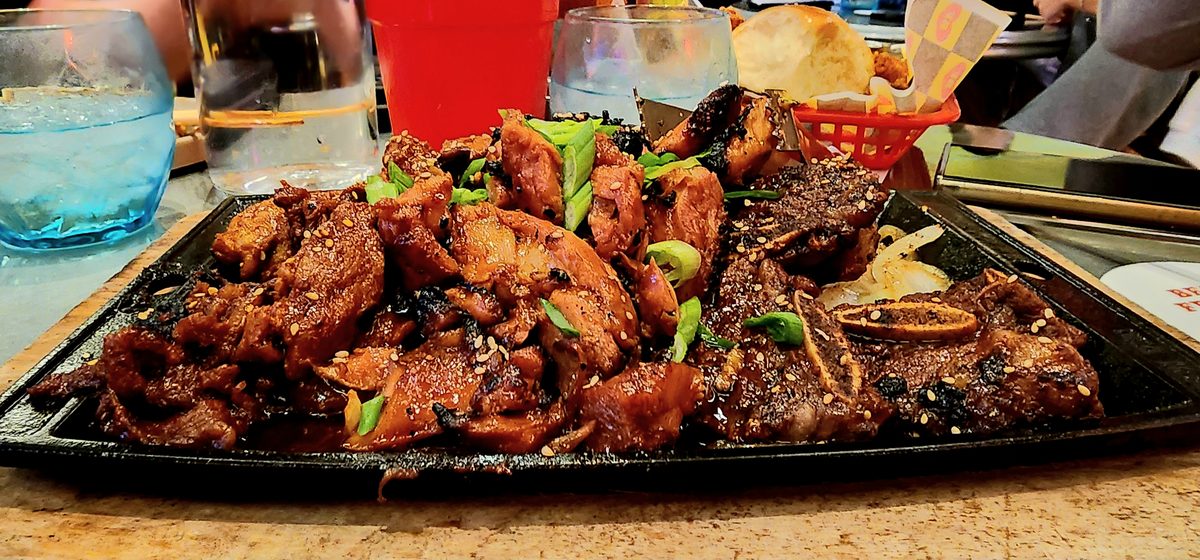 A platter of glazed chicken wings on a restaurant table