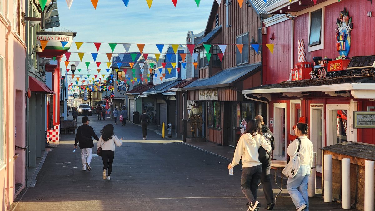 A colorful wharf street with shops and string flags in the morning