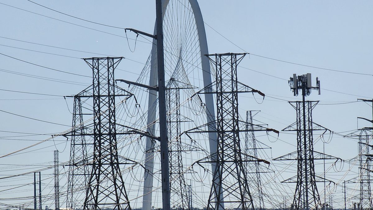 Power-line towers in front of the Margaret Hunt Hill Bridge arch in Dallas