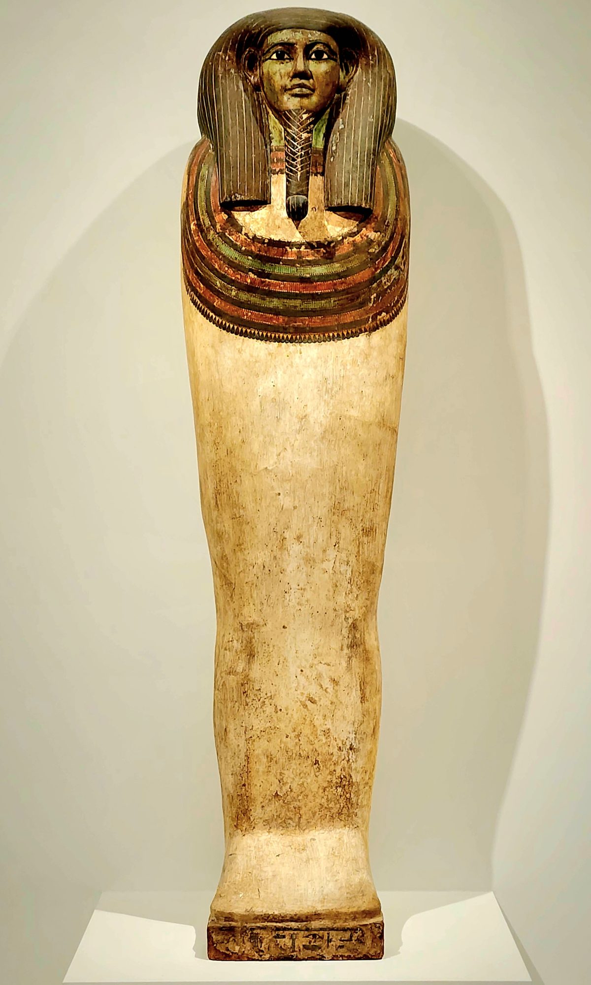 An ancient painted Egyptian coffin on display in a museum