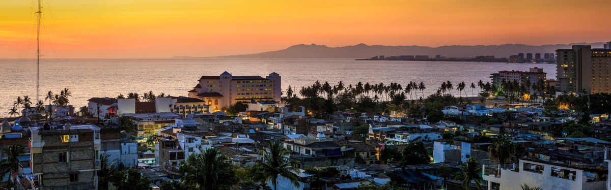 Panorama of a seaside town and bay glowing in the evening sunset light