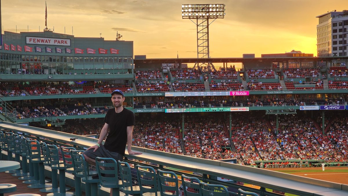 View over a packed Fenway Park in Boston with a golden sunset sky