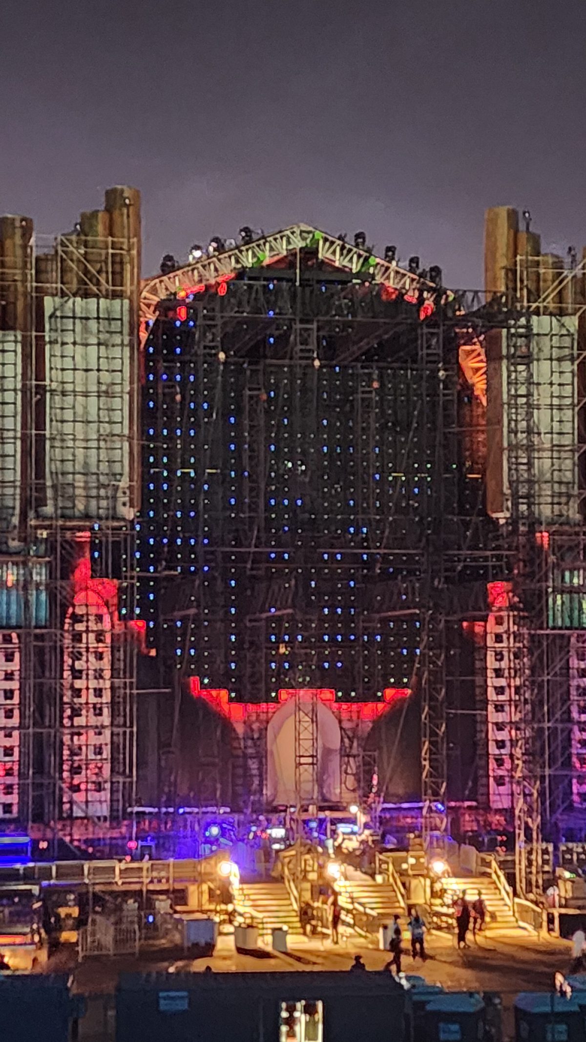 A massive ornate festival stage lit up at night