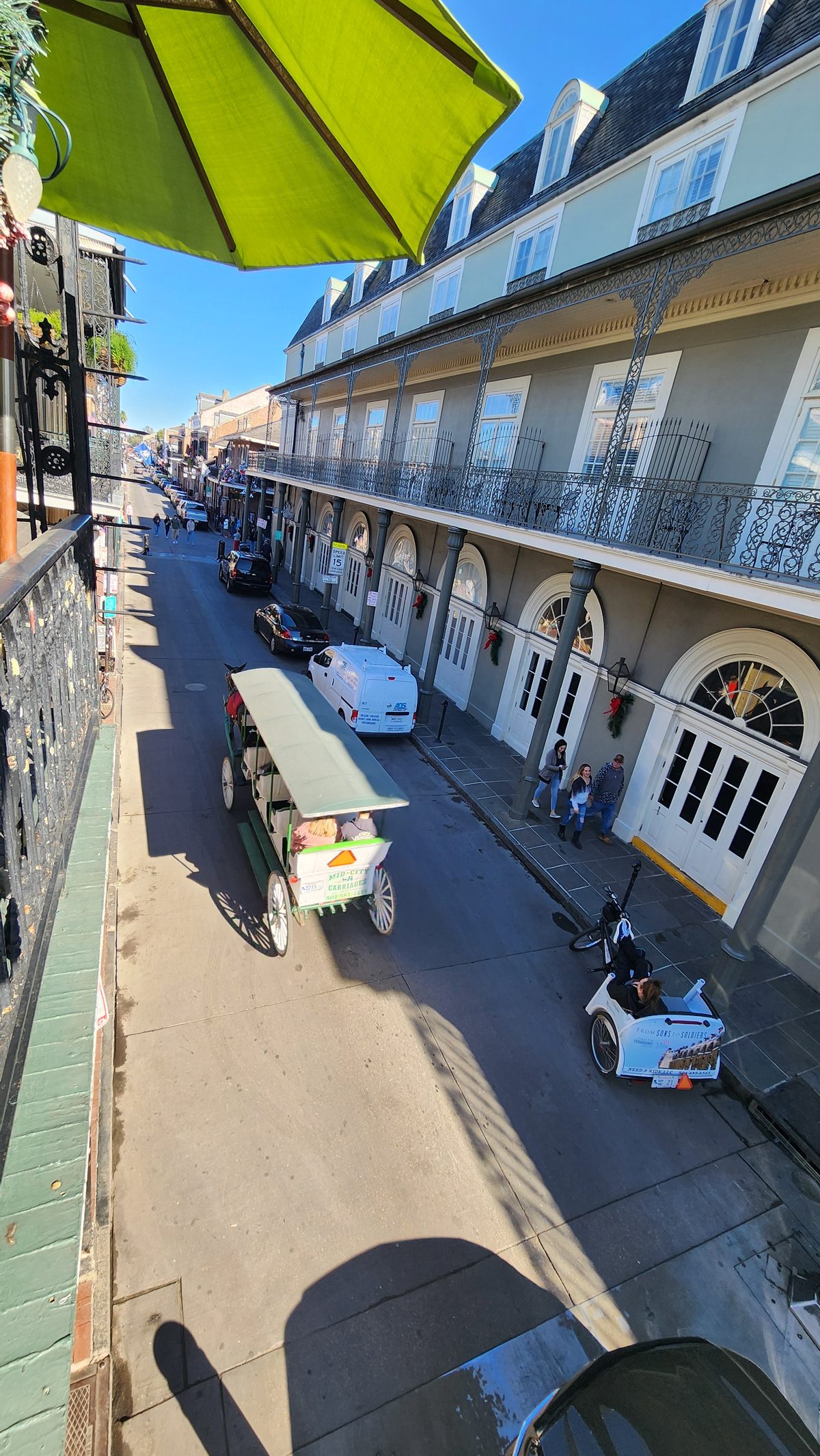 Iron-railed balconies lining a French Quarter street in New Orleans