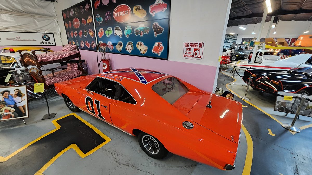 An orange 1969 Charger 'General Lee' replica in a car museum
