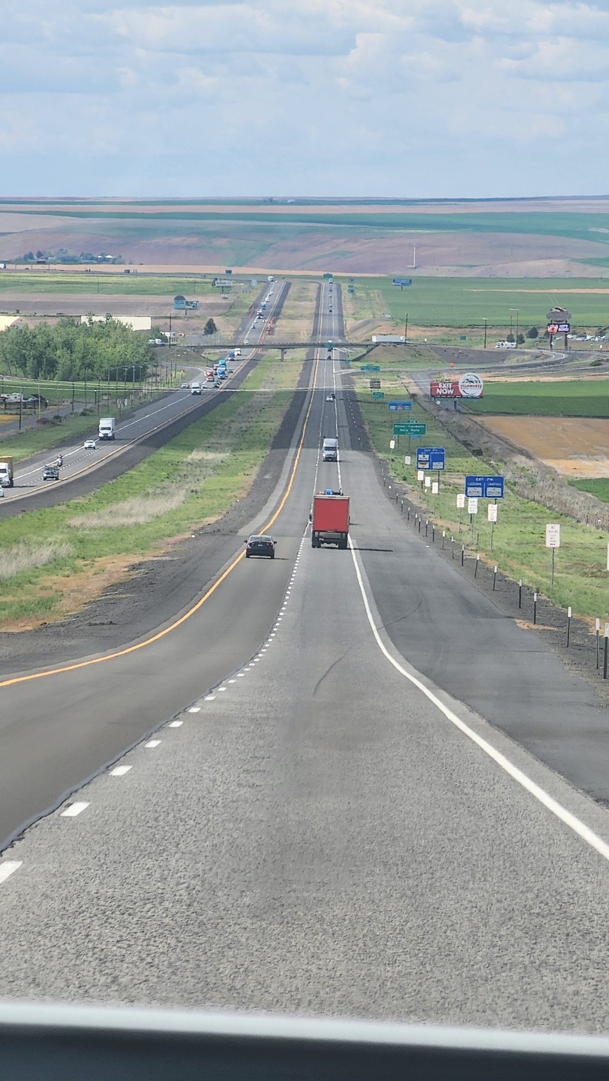 A straight interstate highway running through flat farmland