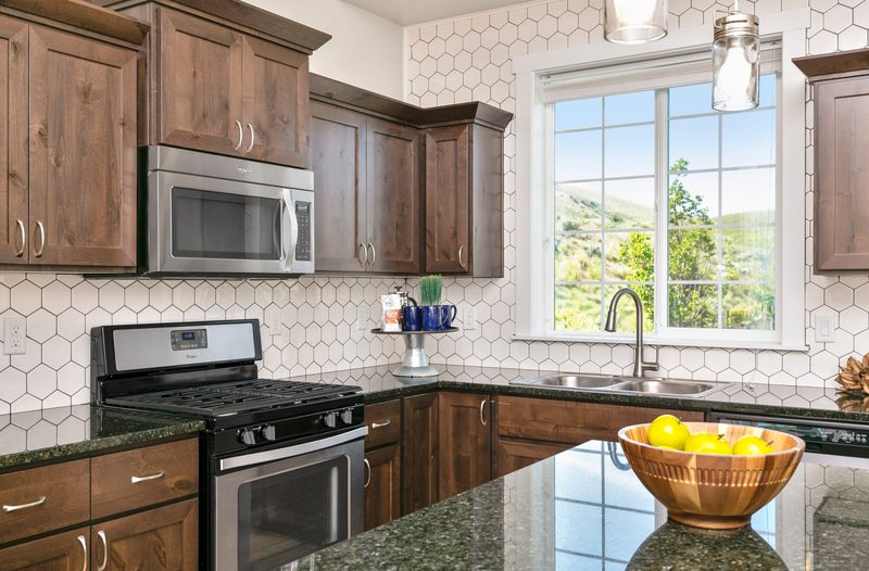 Kitchen with a gas range, granite counters and a window over the sink