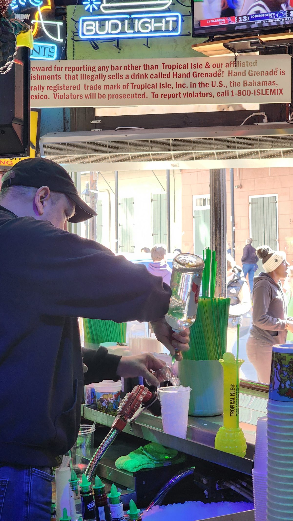 A man ordering at a colorful frozen daiquiri bar in New Orleans