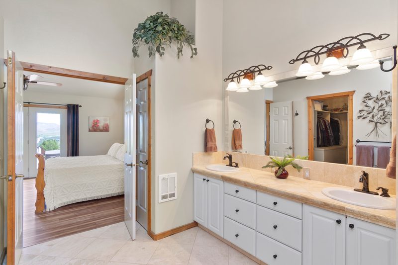 Bathroom double vanity opening into a primary bedroom