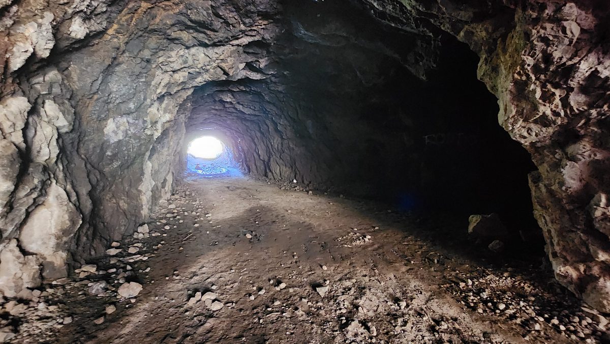 Light at the end of a rough-hewn rock tunnel