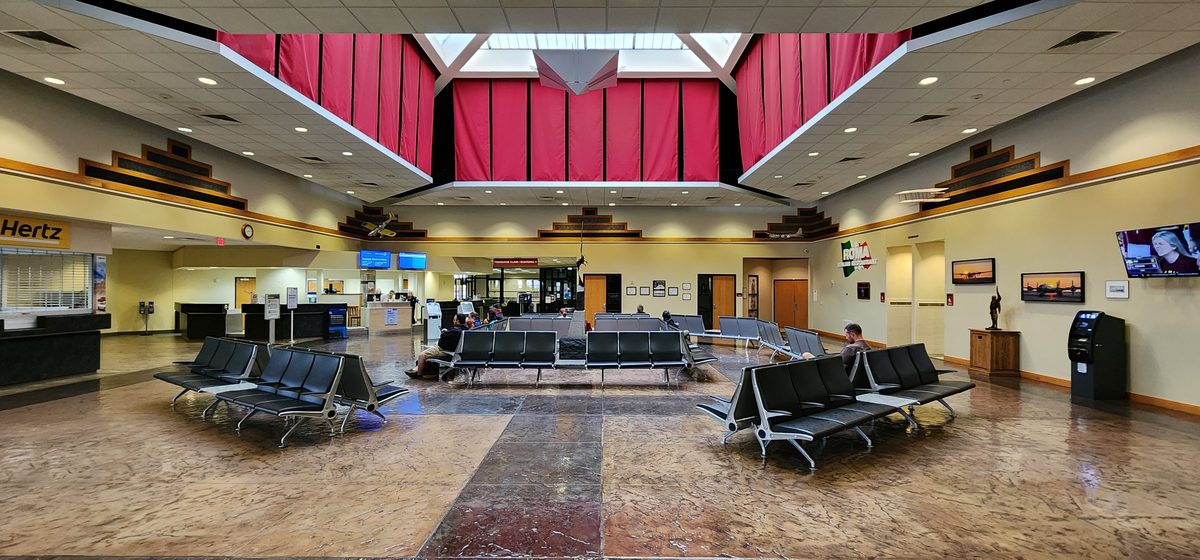 A quiet small-airport terminal with rows of seats