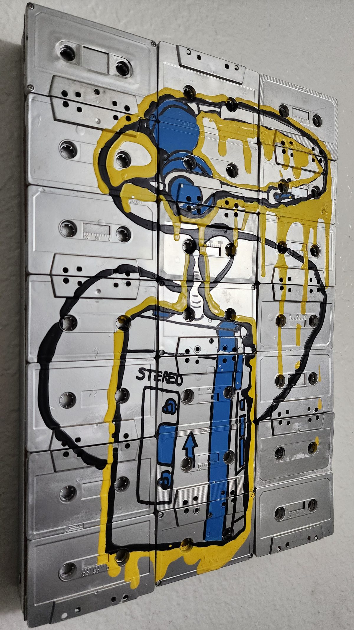 A painted street-art panel of a cartoon robot on a metal door