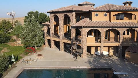 Drone reveal of a stone castle-style villa on a vineyard hill in Idaho