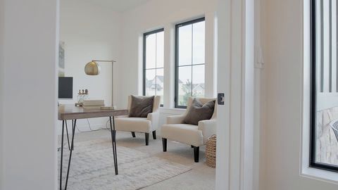 Smooth gimbal tour through a bright white modern farmhouse kitchen and living room