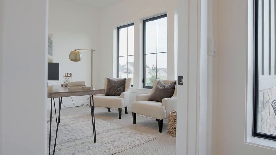 Smooth gimbal tour through a bright white modern farmhouse kitchen and living room